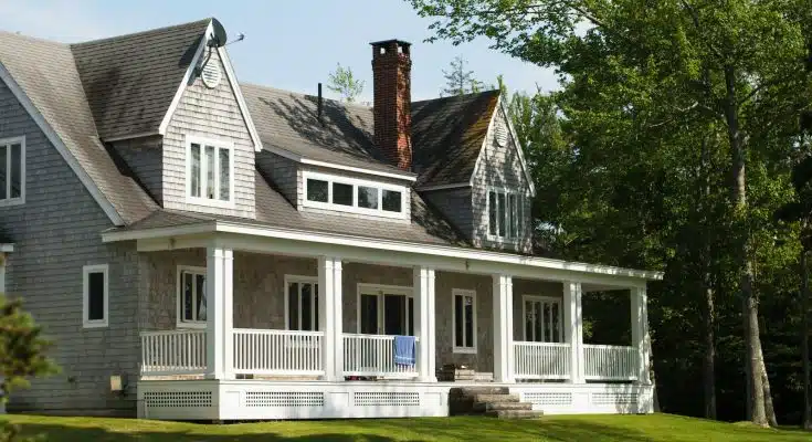 white and brown wooden house near green trees during daytime